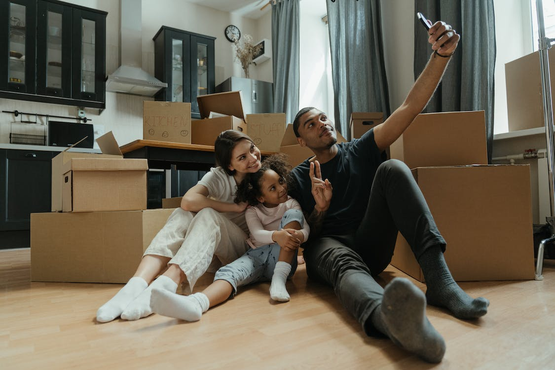 A family is taking a selfie in their new home