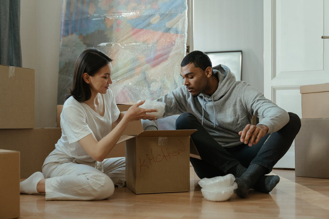 A couple is unpacking boxes in their new home